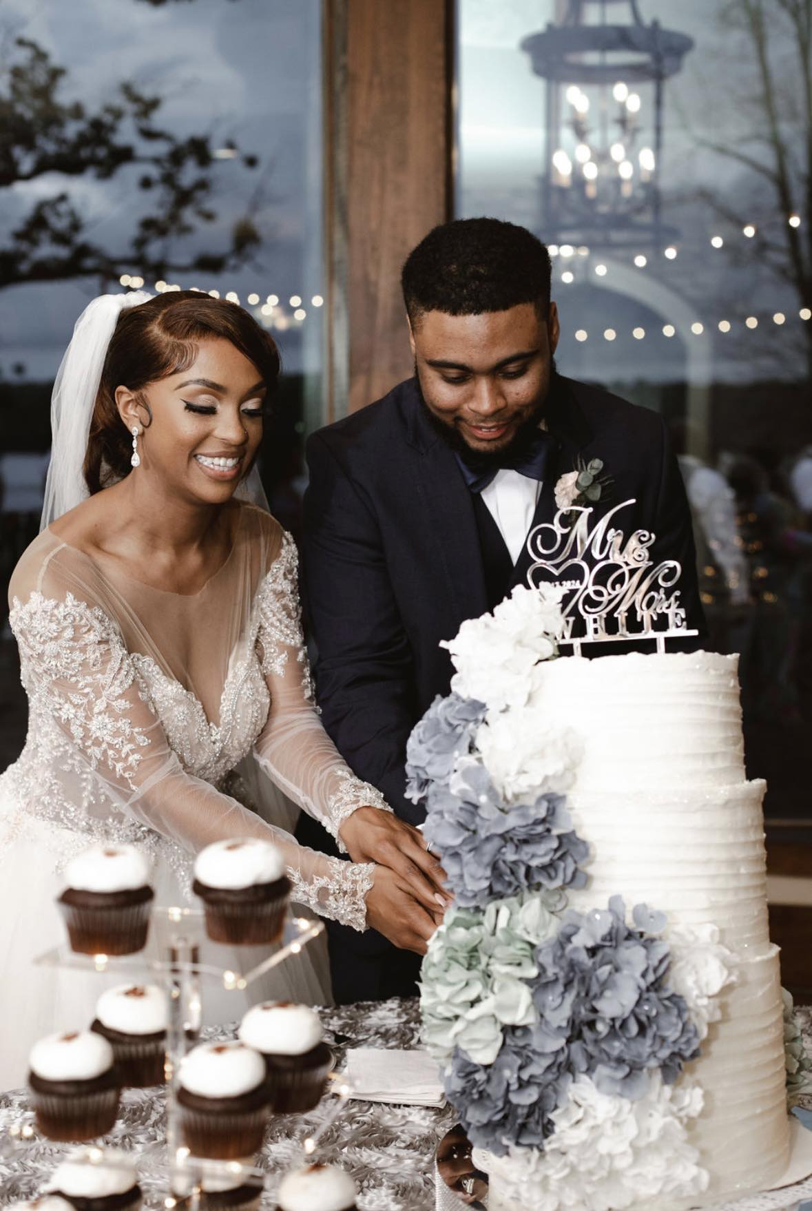 Wedding couple by cake